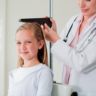 Child at a pediatrician office getting height measured.